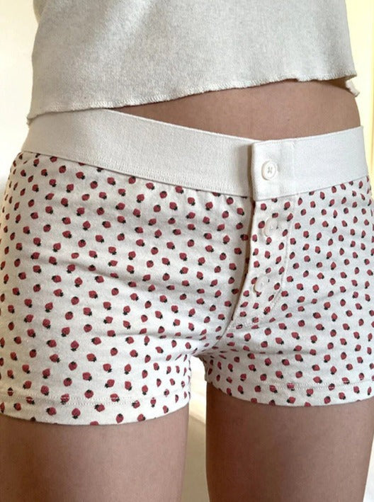 Pantalones cortos con botones y estampado de fresas blancas 