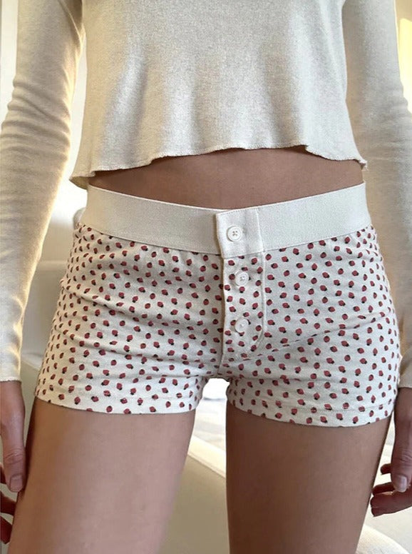 Pantalones cortos con botones y estampado de fresas blancas 