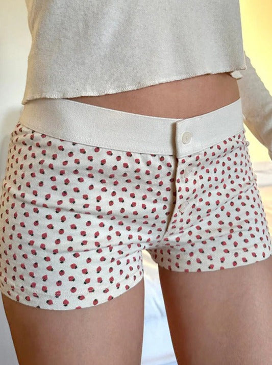 Pantalones cortos con botones y estampado de fresas blancas 