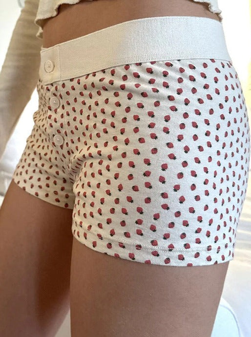 Pantalones cortos con botones y estampado de fresas blancas 